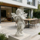 White marble cherub angel flute statue displayed on a modern patio, adding a soft classical touch to outdoor home decor.