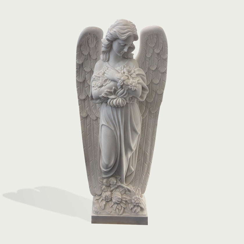 Natural white marble angel statue with feathered wings, floral details, and elegant drapery shown on a clean product background.