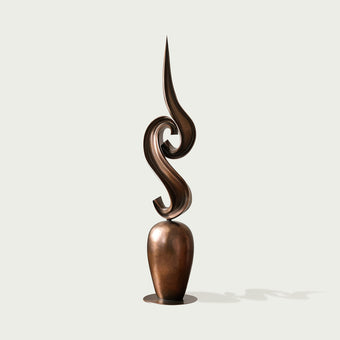 An abstract fluid bronze s-curve sculpture on a white background