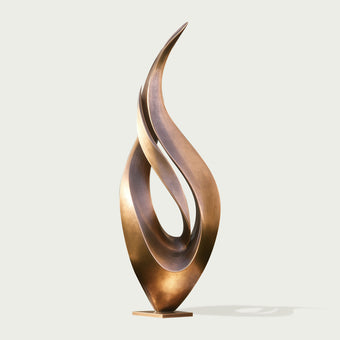Abstract large dancing flame bronze sculpture on a light gray background