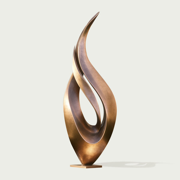 Abstract large dancing flame bronze sculpture on a light gray background