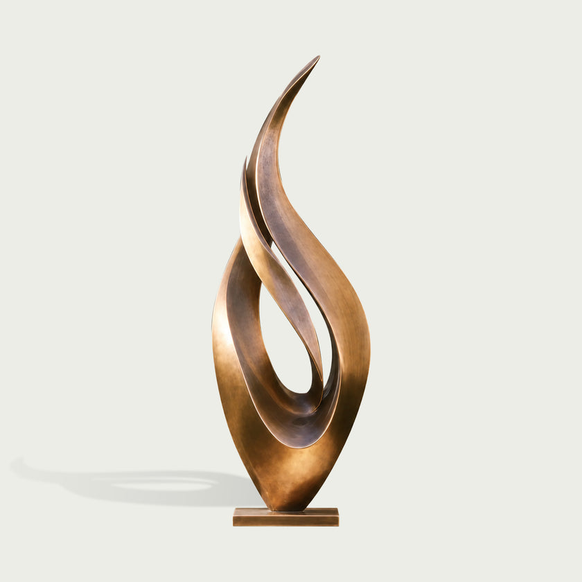 Abstract large dancing flame bronze sculpture on a light gray background