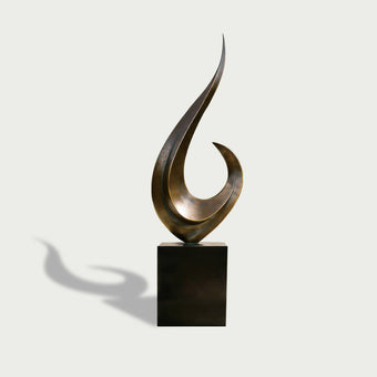 Modern outdoor sweeping crescendo abstract bronze sculpture on a black base against a white background
