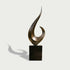 Modern outdoor sweeping crescendo abstract bronze sculpture on a black base against a white background