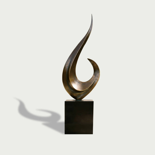 Modern outdoor sweeping crescendo abstract bronze sculpture on a black base against a white background