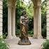 Traditional Crowned Virgin Mary and Baby Jesus Bronze Sculpture in an outdoor setting with columns and greenery.