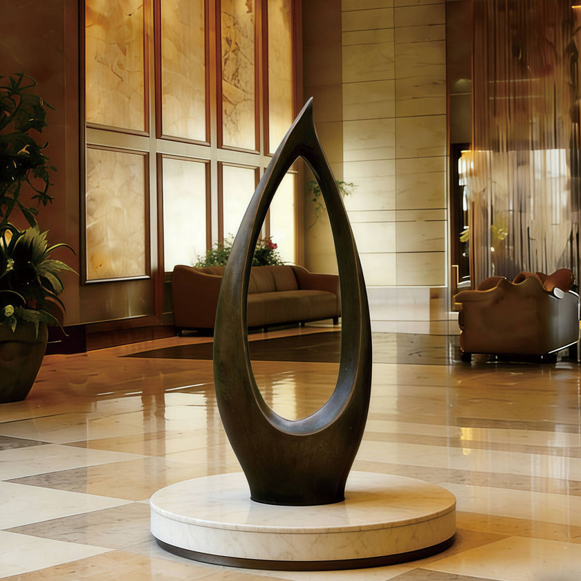 Modern  Abstract Teardrop Bronze Sculpture in a luxurious interior setting with marble floors and elegant decor.