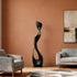 Modern living room with Contemporary Abstract Sculpture Elegant Muse, gray armchair, and sofa against a brown wall.