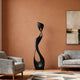 Modern living room with Contemporary Abstract Sculpture Elegant Muse, gray armchair, and sofa against a brown wall.