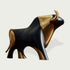 Striking Black And Gold Bronze Bull Statue with black and gold colors on a light gray background