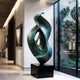 Large Verdigris Abstract Floor Sculpture  in a modern minimalist gallery