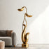  Modern Abstract Gold Floral Sculpture in a living room setting with a sofa and neutral decor.