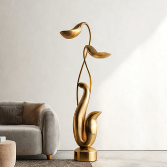  Modern Abstract Gold Floral Sculpture in a living room setting with a sofa and neutral decor.