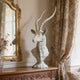  Textured Classic Antelope Bust Statue Bronze Sculpture on a wooden console table with floral curtains and a mirror in the background