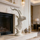 Graceful Antelope Profile Head Bust Bronze  on a fireplace mantel in a home setting