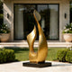 Abstract Botanical Sprout Modern Bronze Sculptures on a patio with a house and garden in the background