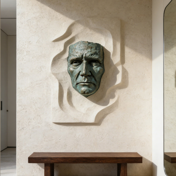 Dramatic Male Wall Art Bronze Sculpture on a textured wall with a wooden console table below.