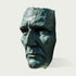Dramatic Male Wall Art Bronze Sculpture of a face on a white background