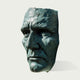 Dramatic Male Wall Art Bronze Sculpture of a face on a white background