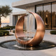 Abstract Contemporary Crescent Bronze Sculpture Water Fountain in front of a courtyard in a luxury villa by coast 