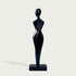 Graceful Female Silhouette Glossy Black Bronze Sculpture standing on a rectangular black base against a light gray background.