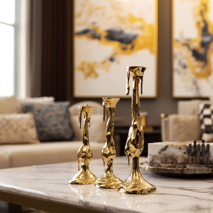 Melting Candle Fluid Abstract Bronze Sculpture of different heights displayed on a marble coffee table in a modern living room setting.