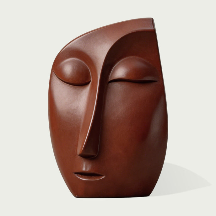 Serene Meditative Face Abstract Bronze Sculpture with closed eyes, photographed against a light gray background.