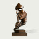 Silent Watcher Head Sculpture Bronze Outdoor Statuary of a human head and hand in profile, with the index finger resting against the lips in a shushing gesture, mounted on a rectangular bronze base against a light gray background.
