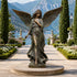 Classic Winged Guardian Angel Bronze Sculpture Garden Large Statues with outstretched wings stands on a round stone pedestal in a formal garden pathway. Tall cypress trees, flowerbeds, balustrades, and a scenic bay and mountains are visible in the background.
