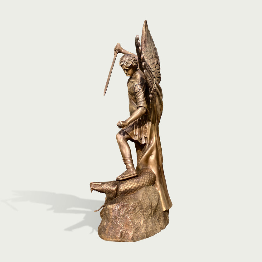 Holy Defender Classical Archangel St. Michael Bronze Sculpture of a winged angel standing on a serpent, holding a sword aloft, set against a plain light gray background.