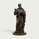 St. Mark The Evangelist Bronze Sculpture Classical Sculpture in draped robes, holding an open book and raising one hand, displayed on a round pedestal against a light gray background.