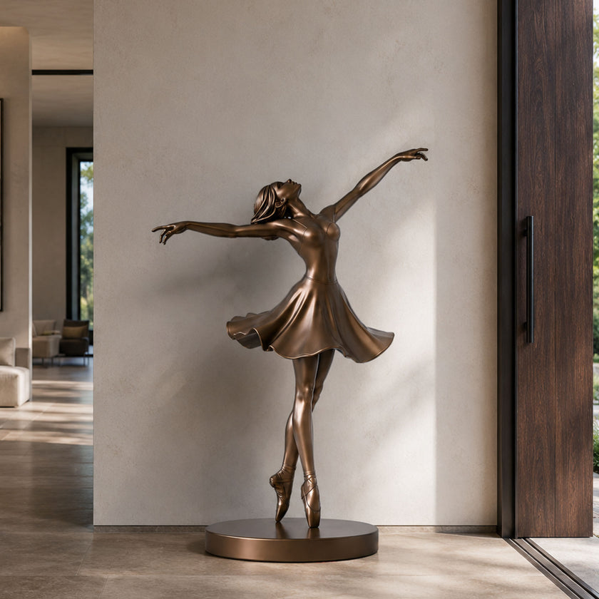 Graceful Ballerina Bronze Statue Life Size Statues in a dynamic pose on a round base, displayed indoors against a light beige wall.