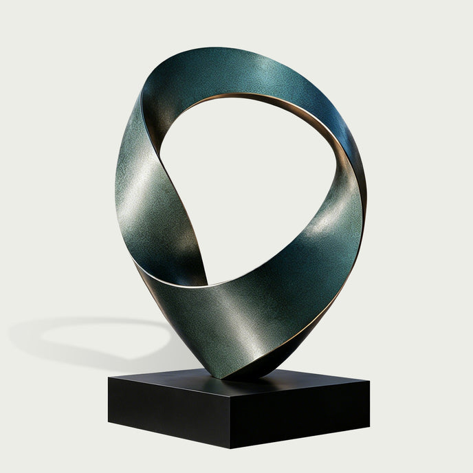 Twisted Emerald Ribbon Abstract Art Sculptures Modern Contemporary Sculpture with a twisted ribbon-like form in dark metallic teal and gray, mounted on a black rectangular base against a light gray background.