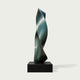 Twisted Emerald Ribbon Abstract Art Sculptures Modern Contemporary Sculpture in a dark metallic teal-green finish, mounted on a rectangular black pedestal against a light gray background.