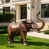 Lucky Raised Trunk Elephant Bronze Sculpture Large Outdoor Statues on a law in front of a luxury villa