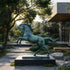 Large bronze horse statue with a dramatic rearing pose and verdigris patina finish, displayed on a dark pedestal in a contemporary landscaped garden.