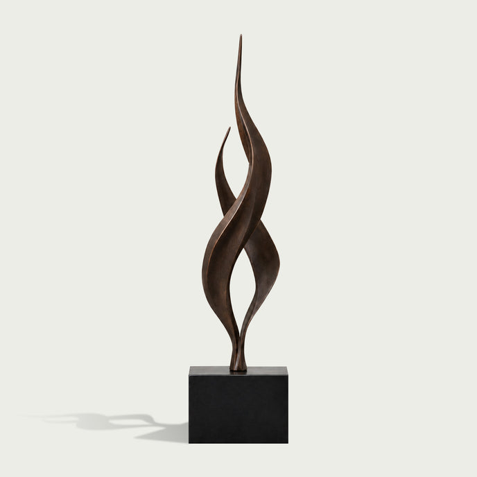 Dual Weave Abstract Bronze Sculpture  with two flowing spiral forms rising from a black rectangular base, photographed against a light warm gray background.