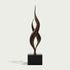 Dual Weave Abstract Bronze Sculpture  with two flowing spiral forms rising from a black rectangular base, photographed against a light warm gray background.