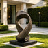 Infinite Loop Bronze Abstract Sculpture Modern Yard Art in a modern garden