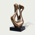 Modern abstract bronze sculpture featuring smooth organic curves, asymmetrical open spaces, a warm brown metallic surface, and a rectangular black display base.