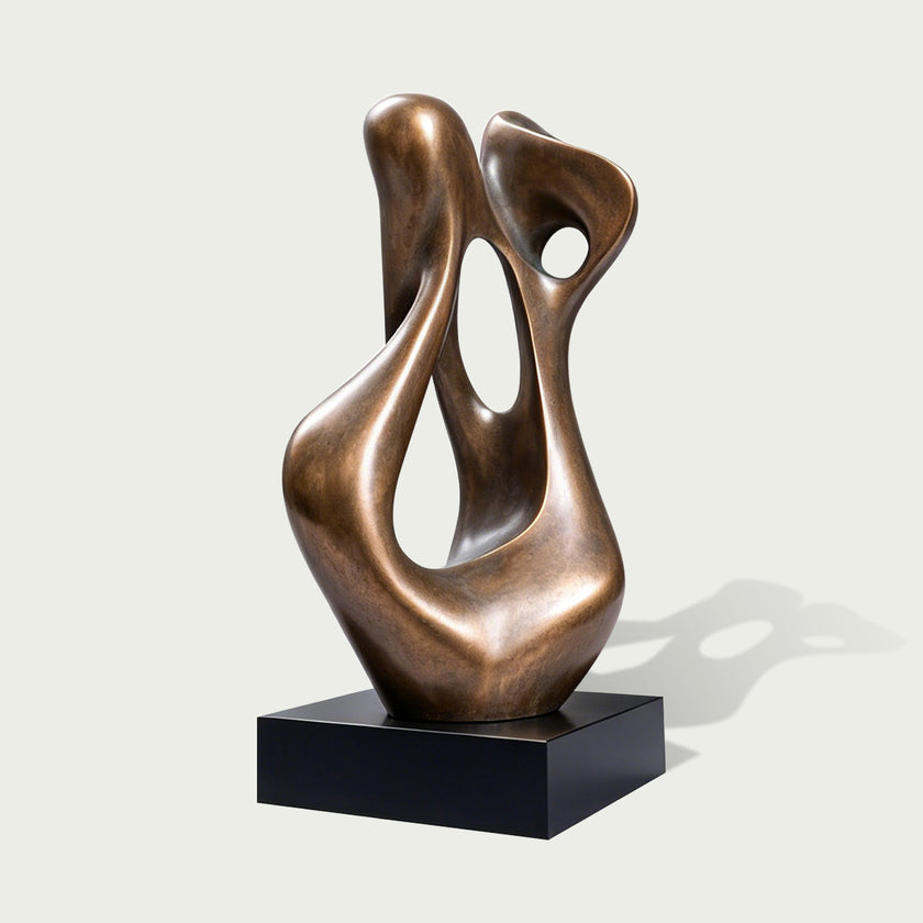 Modern abstract bronze sculpture featuring smooth organic curves, asymmetrical open spaces, a warm brown metallic surface, and a rectangular black display base.
