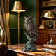 Realistic bronze owl sculpture perched on a textured tree branch in an elegant study, featuring layered feather details, alert eyes, raised ear tufts, and a verdigris-accented base displayed on a wooden desk.