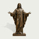 Front view of a life-size bronze Jesus Christ statue with open arms, detailed facial features, long hair, beard, and deeply sculpted flowing robes.