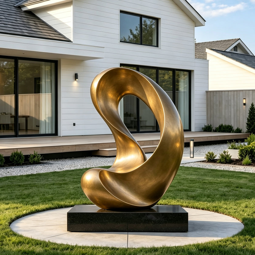 Large abstract bronze sculpture with an elegant continuous loop and fluid organic curves, displayed on a black pedestal in the landscaped garden of a modern luxury residence.