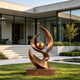 Large contemporary abstract bronze sculpture featuring sweeping flame-like curves surrounding a suspended sphere, displayed on a bronze pedestal in the landscaped garden of a modern luxury residence.