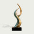 Contemporary abstract bronze sculpture featuring intertwined sweeping curves with green verdigris patina and polished golden bronze edges embracing a smooth white sphere on a black rectangular base.