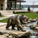 A realistic cast bronze sculpture of a grizzly bear holding a fish in its mouth. The highly textured wildlife metal art features a dynamic hunting pose, set beautifully next to a rocky backyard stream with a lakeside view.