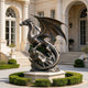 A large bronze sculpture of a majestic winged dragon. This fierce metal art features detailed scales, sharp horns, and spread wings, displayed gracefully in the center of a luxury circular driveway outside a classic grand mansion.