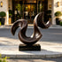 Dynamic Sweeping Curve Contemporary Bronze Sculptures in front of a hotel at the entrance