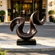Dynamic Sweeping Curve Contemporary Bronze Sculptures in front of a hotel at the entrance